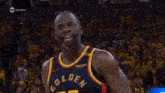 a basketball player wearing a golden jersey number 23
