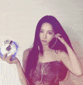 a woman wearing headphones is holding a device that says ' sd ' on it