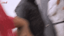 a blurry picture of a woman in a red dress and a man in a white karate uniform .