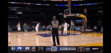 a basketball game is being played and the referee has the number 34 on his jersey