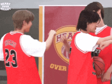 a group of basketball players wearing red jerseys with the number 23 on the back