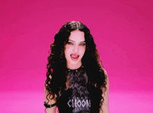 a woman sticking her tongue out wearing a choom shirt