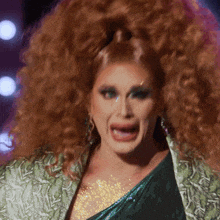 a close up of a woman with red hair making a face