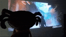 a person holding a stuffed animal in front of a screen that says clidea.com