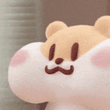 a close up of a stuffed animal with a mustache on it