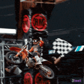 a person on a dirt bike with a flag that says last lap on it