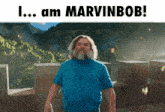 a man in a blue shirt stands in front of a mountain with the words i am marvinbob