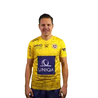 a man wearing a yellow shirt that says uniqa
