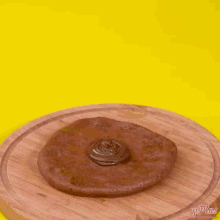 a hand is reaching for a cookie on a tray of cookies