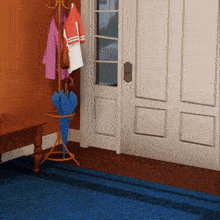 a blue umbrella sits on a stand in front of a white door