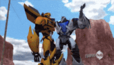 two transformers are standing next to each other with a new hub logo in the background