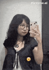 a woman is taking a selfie in front of a mirror with her phone .