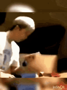 a man in a white hat is sitting at a table with a dog .