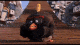 a black angry bird from the angry birds movie is standing on a wooden platform .