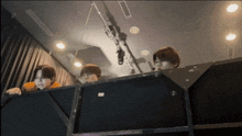 a group of people sitting in front of a microphone in a room