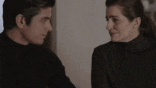 a man and a woman are looking into each other 's eyes
