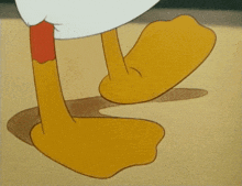 a close up of a cartoon character 's feet on a sandy surface