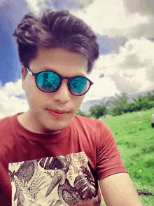 a man wearing sunglasses and a t-shirt that says ' dream ' on it