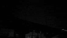 a black and white photo of a train going down a hill