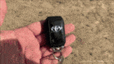 a person is holding a black toyota keychain in their hand