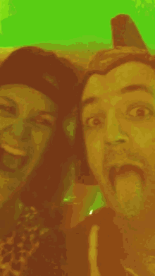 a man sticking out his tongue next to a woman