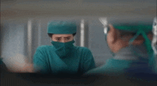 a surgeon with a mask on her face is looking at another surgeon in a hospital room .