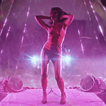a woman in a red dress is standing on a stage