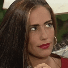 a close up of a woman 's face with red lipstick .