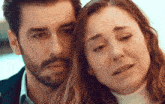 a man with a beard and a woman with tears in her eyes