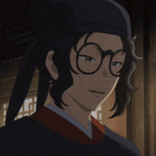 a man wearing glasses and a hat looks at the camera