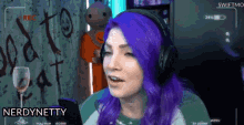a woman with purple hair is wearing headphones while playing a video game