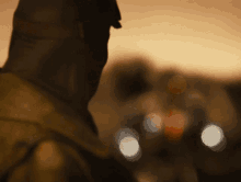 a blurry picture of a person 's back with a blurred background