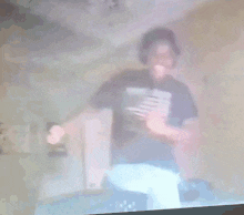 a blurry picture of a man wearing a shirt that says ' who dat '