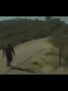 a blurred image of a man walking down a road