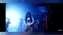 a woman is dancing in a video that says vevo