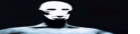 a man with a mask on his face is standing in the dark with a circle in the background .