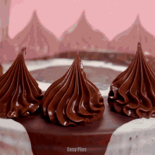 a close up of a chocolate cake with easy plus in the corner