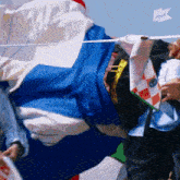 a person holding a flag with an arrow pointing to the right that says ' ithek ' on it