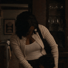 a woman in a white sweater holds a child