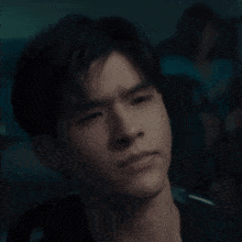 a young man with a serious look on his face