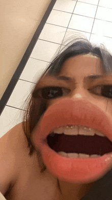 a close up of a woman 's face with her mouth open and her eyes visible