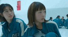 a girl in a blue jacket with the number 067 on it