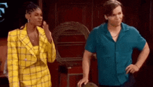 a man and a woman are standing next to each other .