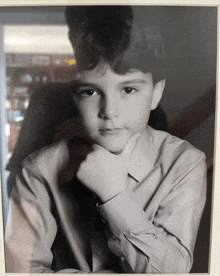 a black and white photo of a young boy