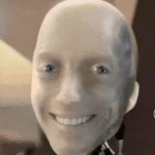 a close up of a bald robot head smiling .