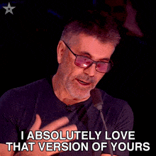 a man speaking into a microphone with the words " i absolutely love that version of yours " below him