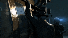 a man in a white helmet is standing in front of a large machine