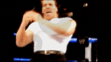 a blurry picture of a man in a white shirt with a belt