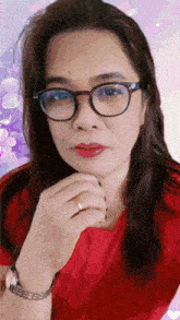 a woman wearing glasses and a red shirt