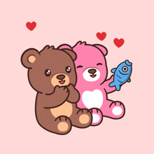a brown teddy bear and a pink teddy bear holding a blue fish